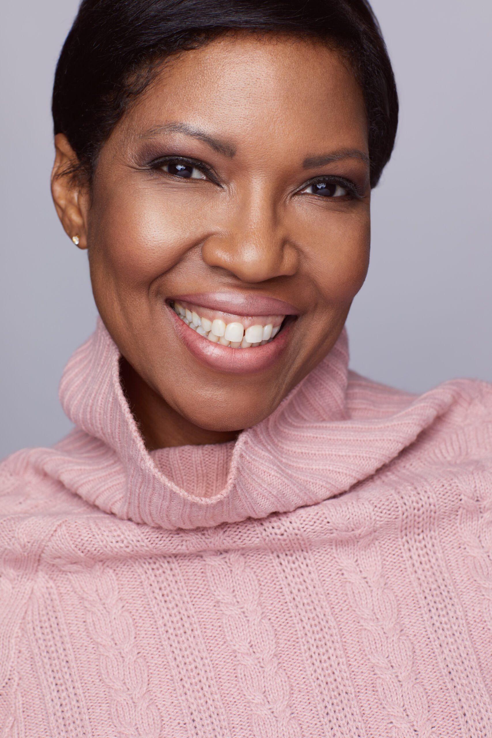Houston's best headshot photographer Angi Lewis Photography headshot of african american woman in pink turtleneck sweater
